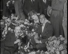 Mary Pickford and Douglas Fairbanks Senior Sitting Together Amongst a Bed of Flowers in Paris, 1920. Creator: British Pathe Ltd