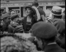 Mary Pickford and Douglas Fairbanks Senior Smiling to Crowds from an Open Topped Car in Paris, 1920. Creator: British Pathe Ltd