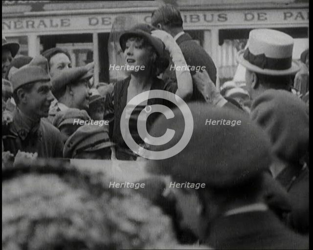 Mary Pickford and Douglas Fairbanks Senior Smiling to Crowds from an Open Topped Car in Paris, 1920. Creator: British Pathe Ltd.