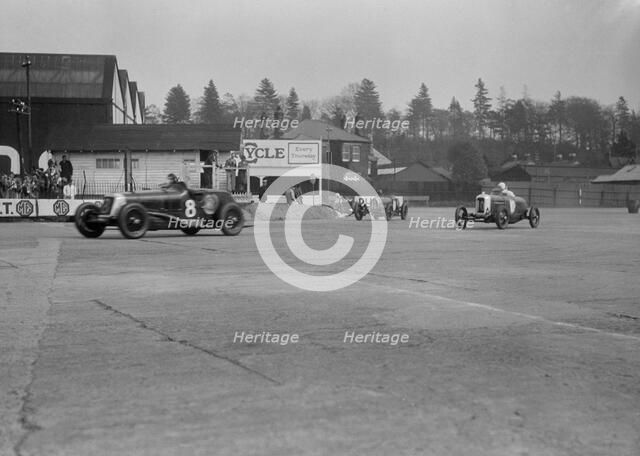Maserati of Richard Oats leading George Harvey-Noble's Bugatti and a Salmson, Brooklands, 1930s. Artist: Bill Brunell.