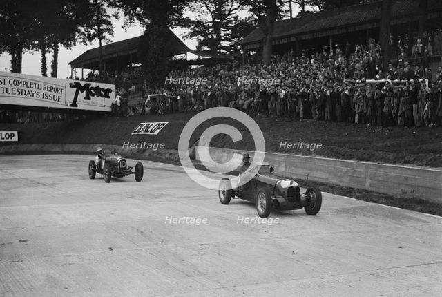 Maserati leading Charles Mortimer's Bugatti Type 35B at Brooklands, Surrey, 1939. Artist: Bill Brunell.