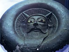 Mask of a river divinity, in bronze