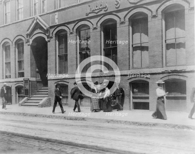 Massachusetts. Lynn. shoe factories, 1895?: sidewalk scene outside Luddy Co., (1895?). Creator: Frances Benjamin Johnston.