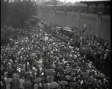 Masses of People Cheering - Many Have Umbrellas As It Is Raining, 1932. Creator: British Pathe Ltd