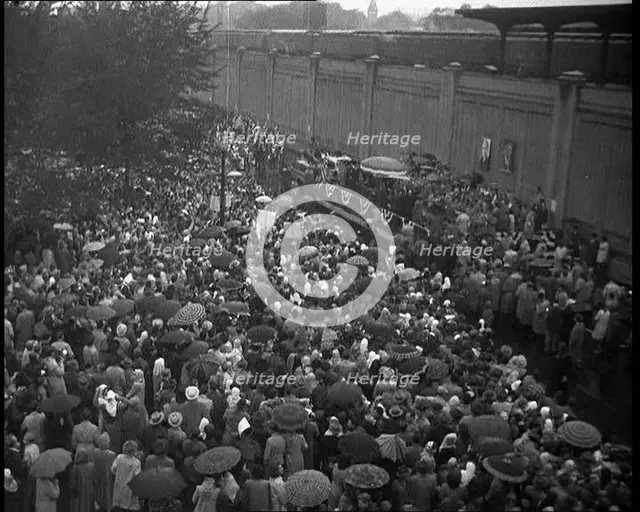 Masses of People Cheering - Many Have Umbrellas As It Is Raining, 1932. Creator: British Pathe Ltd.