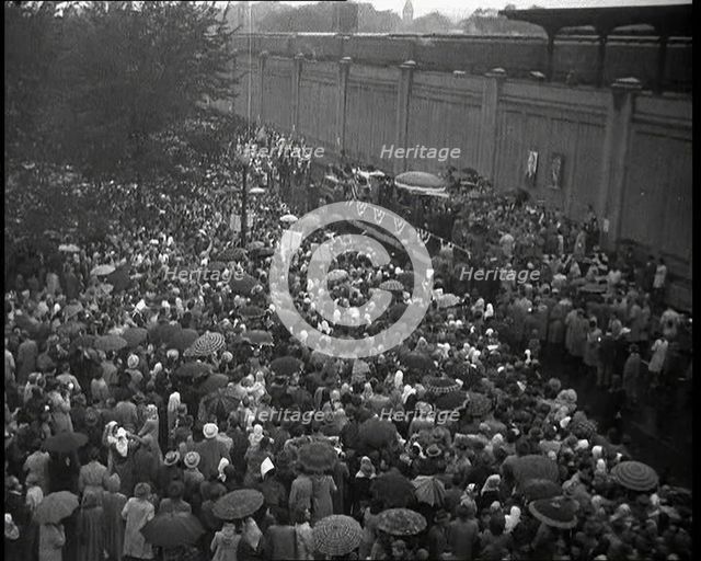 Masses of People Cheering - Many Have Umbrellas As It Is Raining, 1932. Creator: British Pathe Ltd.