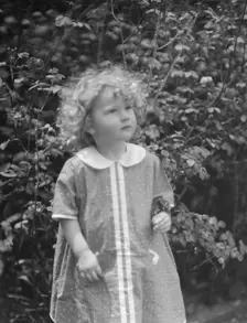 McCormick, Medill, child of, standing outdoors, 1923 May 21. Creator: Arnold Genthe
