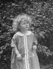 McCormick, Medill, child of, standing outdoors, 1923 May 21. Creator: Arnold Genthe