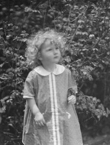 McCormick, Medill, child of, standing outdoors, 1923 May 21. Creator: Arnold Genthe