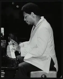 McCoy Tyner performing at the Newport Jazz Festival, Ayresome Park, Middlesbrough, July 1978. Creator: Denis Williams