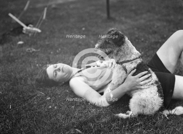 McKeogh, Arthur, Mrs., with dog, outdoors, 1927 Creator: Arnold Genthe.