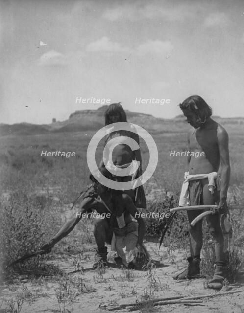 Me Sa Tawa catching snakes-Hopi, c1907. Creator: Edward Sheriff Curtis.