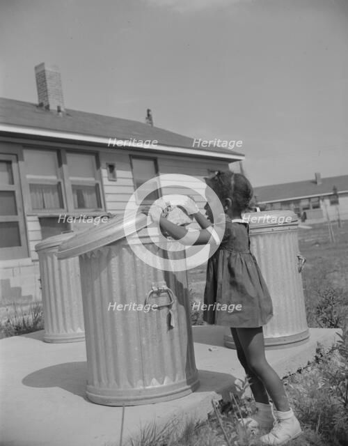 Metal ashcans, Frederick Douglass housing project, Anacostia, D.C., 1942. Creator: Gordon Parks.