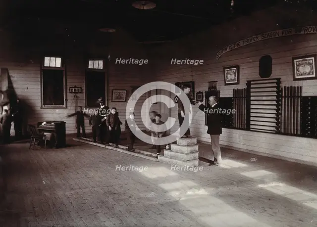 Metropolitan Lunatic Asylum, Kew, Victoria (Australia): boys walking along a ladder laid upon... Creator: Unknown.