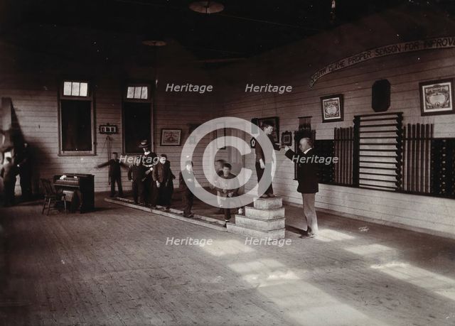 Metropolitan Lunatic Asylum, Kew, Victoria (Australia): boys walking along a ladder laid upon... Creator: Unknown.