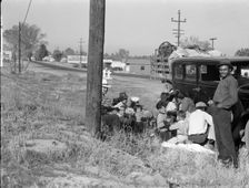 Mexicans bound for the Imperial Valley to harvest peas, near Bakersfield, California, 1936. Creator: Dorothea Lange