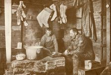 Meares and Demetri at the Blubber Stove in the Discovery Hut 3 November 1911, (1913). Artist: Herbert Ponting