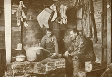 Meares and Demetri at the Blubber Stove in the Discovery Hut 3 November 1911, (1913). Artist: Herbert Ponting