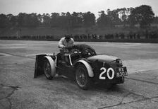 Mechanic making adjustments to a MG C type, Brooklands. Artist: Bill Brunell
