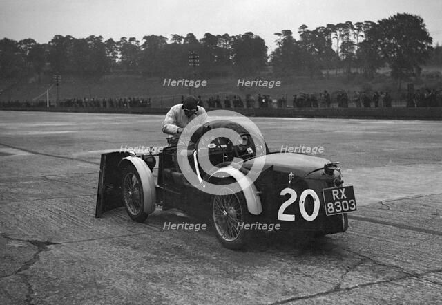 Mechanic making adjustments to a MG C type, Brooklands. Artist: Bill Brunell.