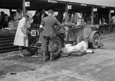 Mechanic working on a Lea Francis J type at the JCC Double Twelve race, Brooklands, May 1931. Artist: Bill Brunell