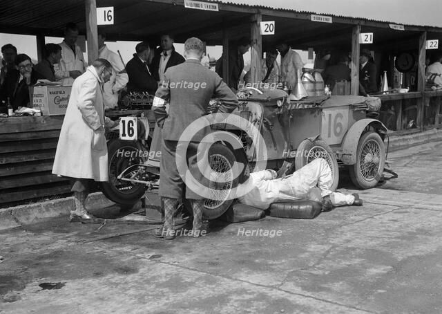 Mechanic working on a Lea Francis J type at the JCC Double Twelve race, Brooklands, May 1931. Artist: Bill Brunell.