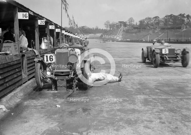Mechanic working on a Lea Francis J type at the JCC Double Twelve race, Brooklands, May 1931. Artist: Bill Brunell.