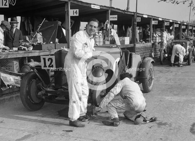 Mechanic working on a Talbot 105 at the JCC Double Twelve race, Brooklands, 8/9 May 1931. Artist: Bill Brunell.