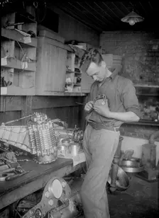 Mechanic working on Raymond Mays 2996 cc Vauxhall-Villiers. Artist: Bill Brunell