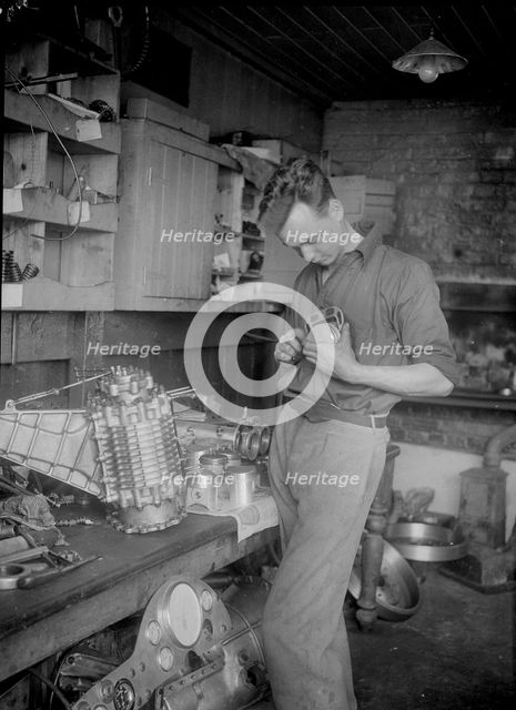 Mechanic working on Raymond Mays' 2996 cc Vauxhall-Villiers. Artist: Bill Brunell.