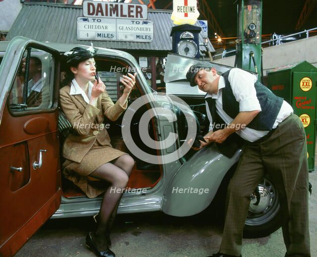 Mechanic with lady driver doing her make up, 1930's Hillman Minx. Artist: Unknown.