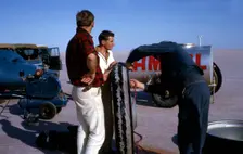 Mechanics inflating Bluebird CN7 tyre for World Land Speed Record attempt, Lake Eyre, 1964. Creator: Unknown