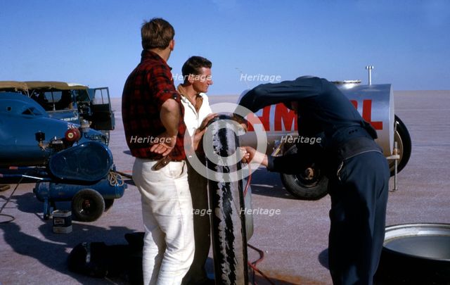 Mechanics inflating Bluebird CN7 tyre for World Land Speed Record attempt, Lake Eyre, 1964. Creator: Unknown.