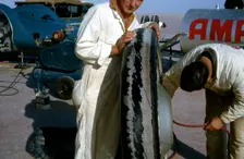 Mechanics inflating Bluebird CN7 tyre for World Land Speed Record attempt, Lake Eyre, 1964. Creator: Unknown