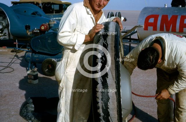 Mechanics inflating Bluebird CN7 tyre for World Land Speed Record attempt, Lake Eyre, 1964. Creator: Unknown.