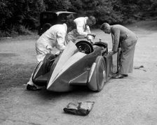 Mechanics working on Leon Cushman's Austin 7 racer for a speed record attempt, Brooklands, 1931. Artist: Bill Brunell