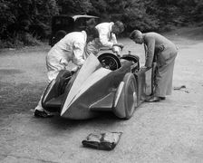 Mechanics working on Leon Cushman's Austin 7 racer for a speed record attempt, Brooklands, 1931. Artist: Bill Brunell