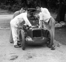 Mechanics working on Leon Cushman's Austin 7 racer for a speed record attempt, Brooklands, 1931. Artist: Bill Brunell