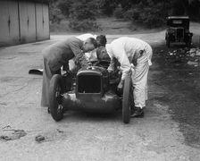 Mechanics working on Leon Cushman's Austin 7 racer for a speed record attempt, Brooklands, 1931. Artist: Bill Brunell