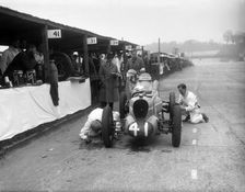 Mechanics working on the MG of Doreen Evans, JCC International Trophy, Brooklands, 1936. Artist: Bill Brunell