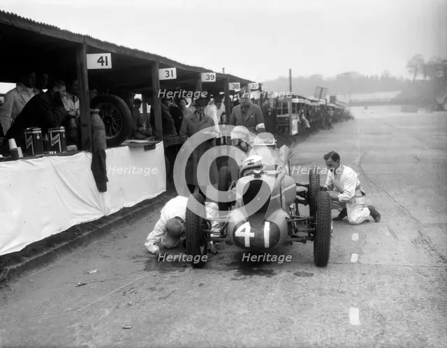 Mechanics working on the MG of Doreen Evans, JCC International Trophy, Brooklands, 1936. Artist: Bill Brunell.