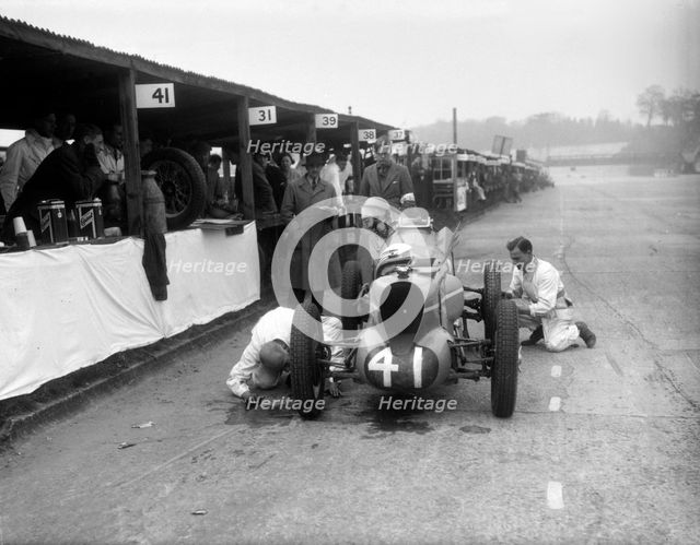 Mechanics working on the MG of Doreen Evans, JCC International Trophy, Brooklands, 1936. Artist: Bill Brunell.