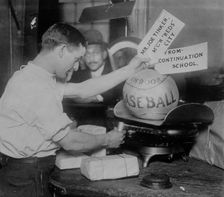 Medicine ball being weighed by Post Office employee; shipping tags read: Mr. Joe Tinker..., 1913. Creator: Bain News Service