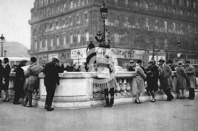 Meeting place at the entrance to a Metro station, Paris, 1931. Artist: Ernest Flammarion