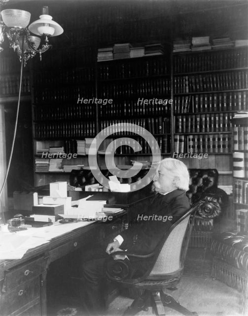 Melville Weston Fuller, full-length portrait, seated at desk, facing left, c1899. Creator: Frances Benjamin Johnston.