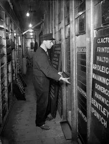 Member of staff changing departure information, Liverpool Street Station, London, 1950