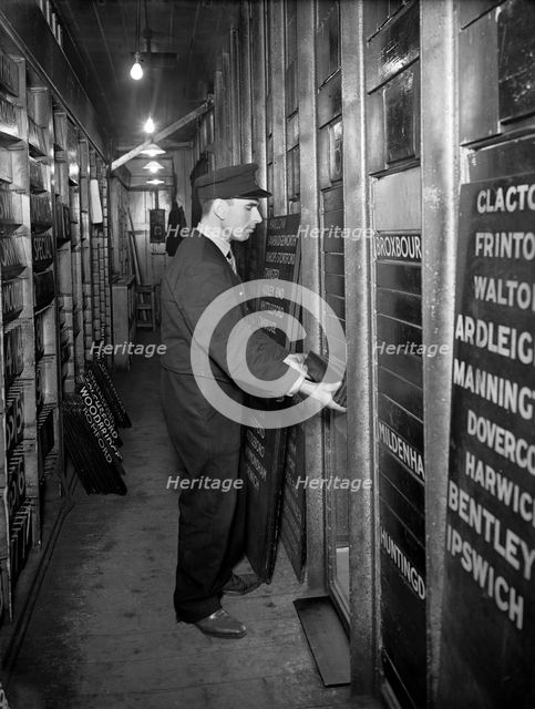 Member of staff changing departure information, Liverpool Street Station, London, 1950. Artist: Unknown