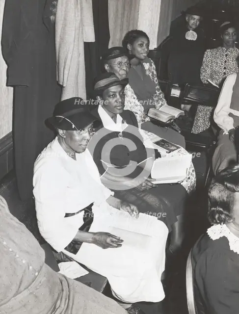 Members of the congregation of the "store front" Baptist Church, Chicago, Illinois, April, 1941. Creators: Farm Security Administration, Russell Lee.