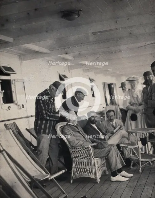 Members of the British Association playing at phrenology on board a ship on its way to..., 1905. Creator: James Thomson Bottomley.