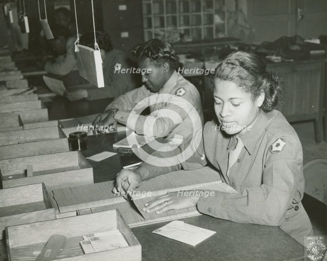 Members of the Women's Army Corps identifying incorrectly addressed mail for soldiers..., 1943. Creator: Unknown.